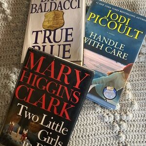 Three hardcover books by best selling authors.